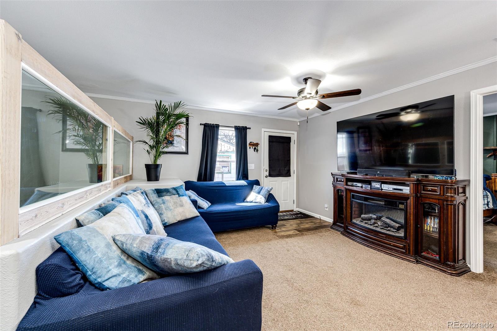 570 4th Street Bennett, CO 80102 - Photo 8 of 36 a living room with furniture and a flat screen tv