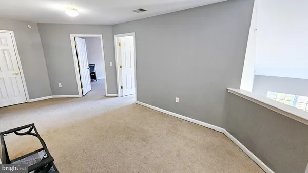 a view of a livingroom with furniture and stairs