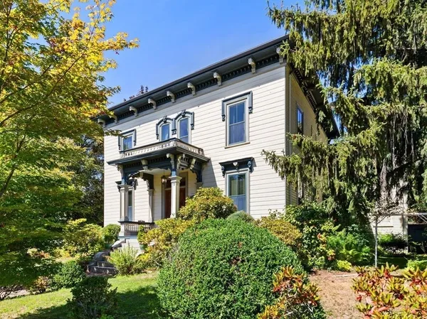 a front view of a house with a garden