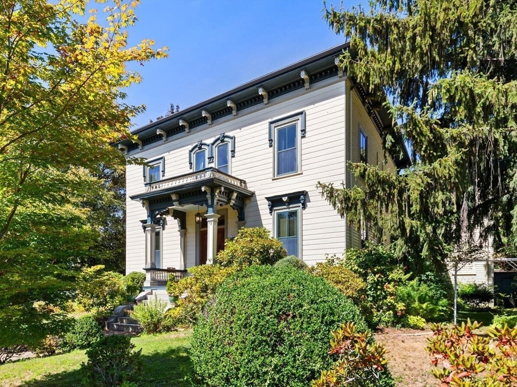 a front view of a house with a garden