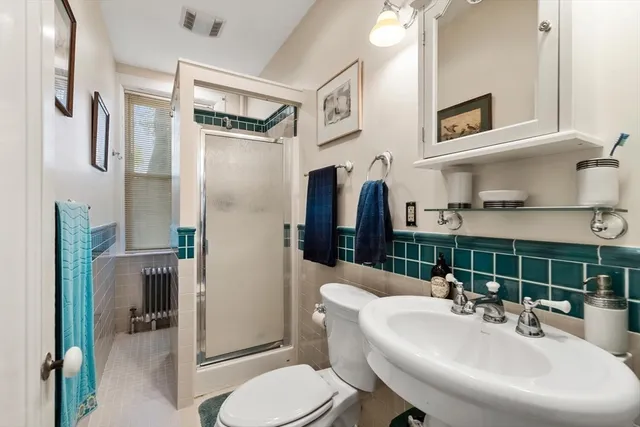 a bathroom with a sink toilet and shower