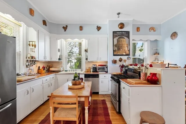 a kitchen filled a sink a counter space and appliances
