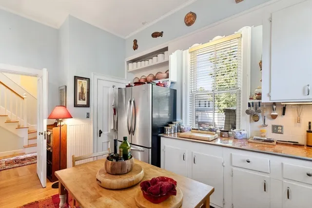 a kitchen with stainless steel appliances a sink a window and cabinets