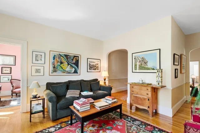 a living room with furniture and painting on the wall