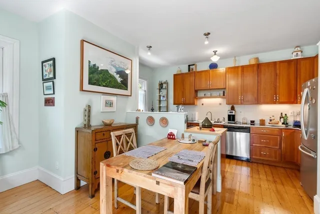 a kitchen with stainless steel appliances wooden cabinets and a refrigerator