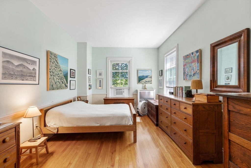 41 Dearborn Street Salem, MA 01970 - Photo 29 of 37 a bedroom with a bed and wooden floor