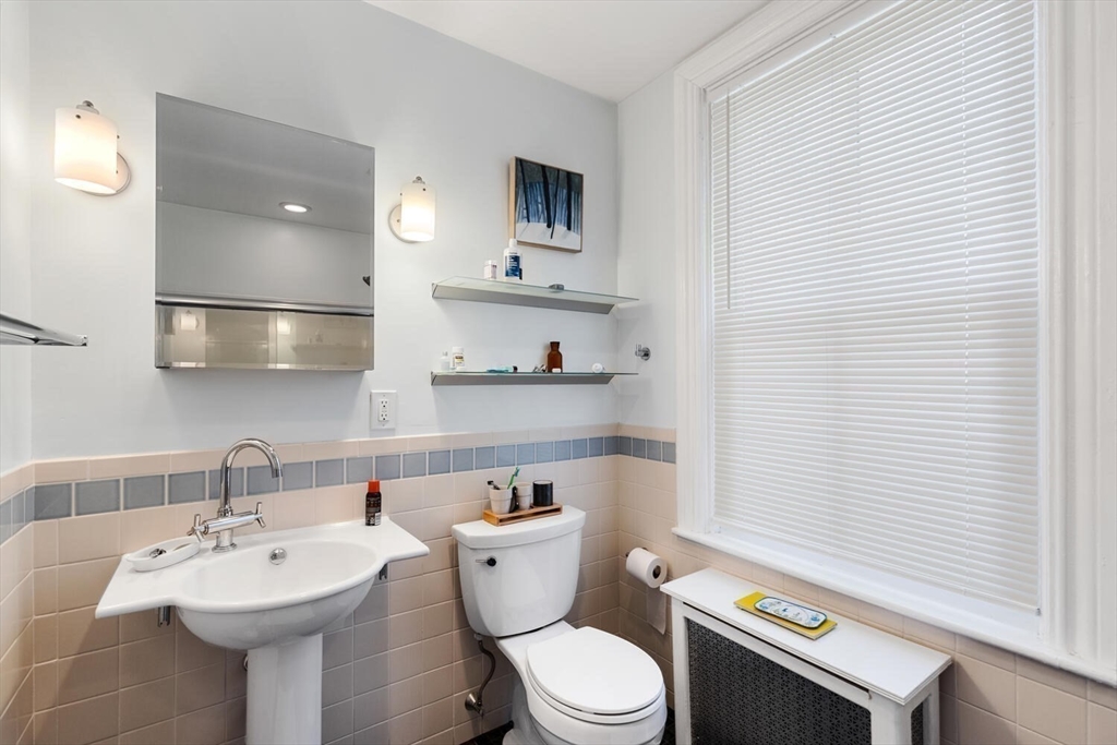 41 Dearborn Street Salem, MA 01970 - Photo 31 of 37 a bathroom with a sink a toilet and mirror