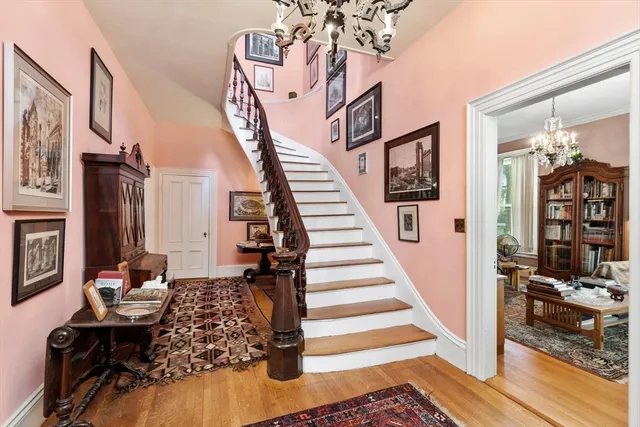 a view of entryway and hall with wooden floor