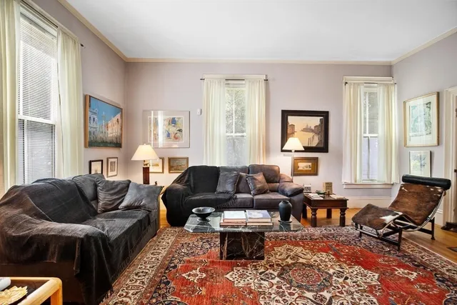 a living room with furniture fireplace and a window
