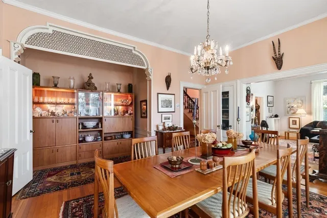 a view of a dining room with furniture and a chandelier