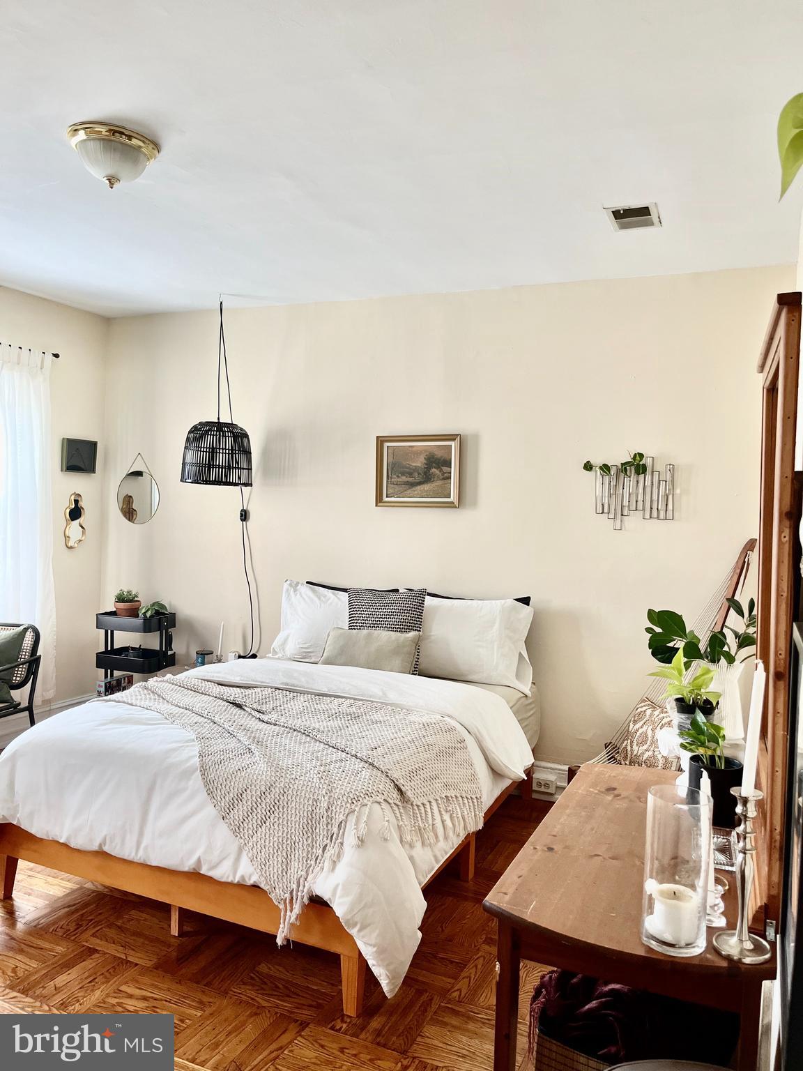 4253 Ridge Avenue, Unit 3R Philadelphia, PA 19129 - Photo 1 of 9 a bedroom with a bed and a table