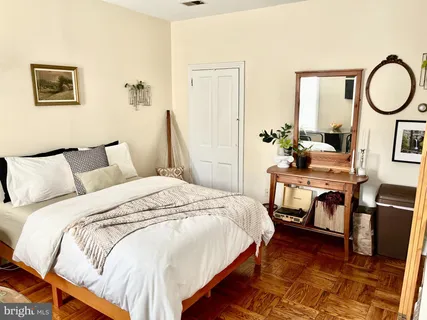 a bed room with a bed and a chair