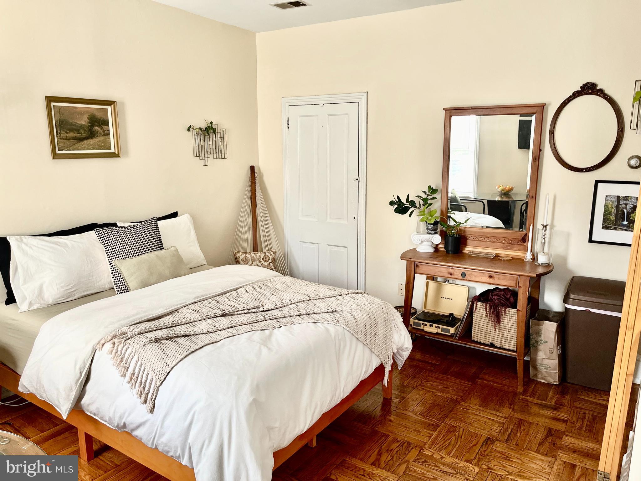 4253 Ridge Avenue, Unit 3R Philadelphia, PA 19129 - Photo 2 of 9 a bed room with a bed and a chair