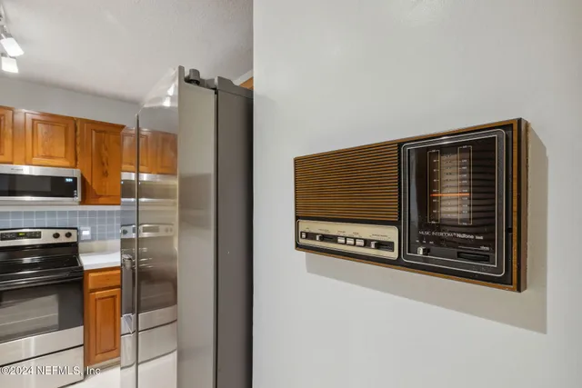 a kitchen with wooden cabinets and a stove top oven