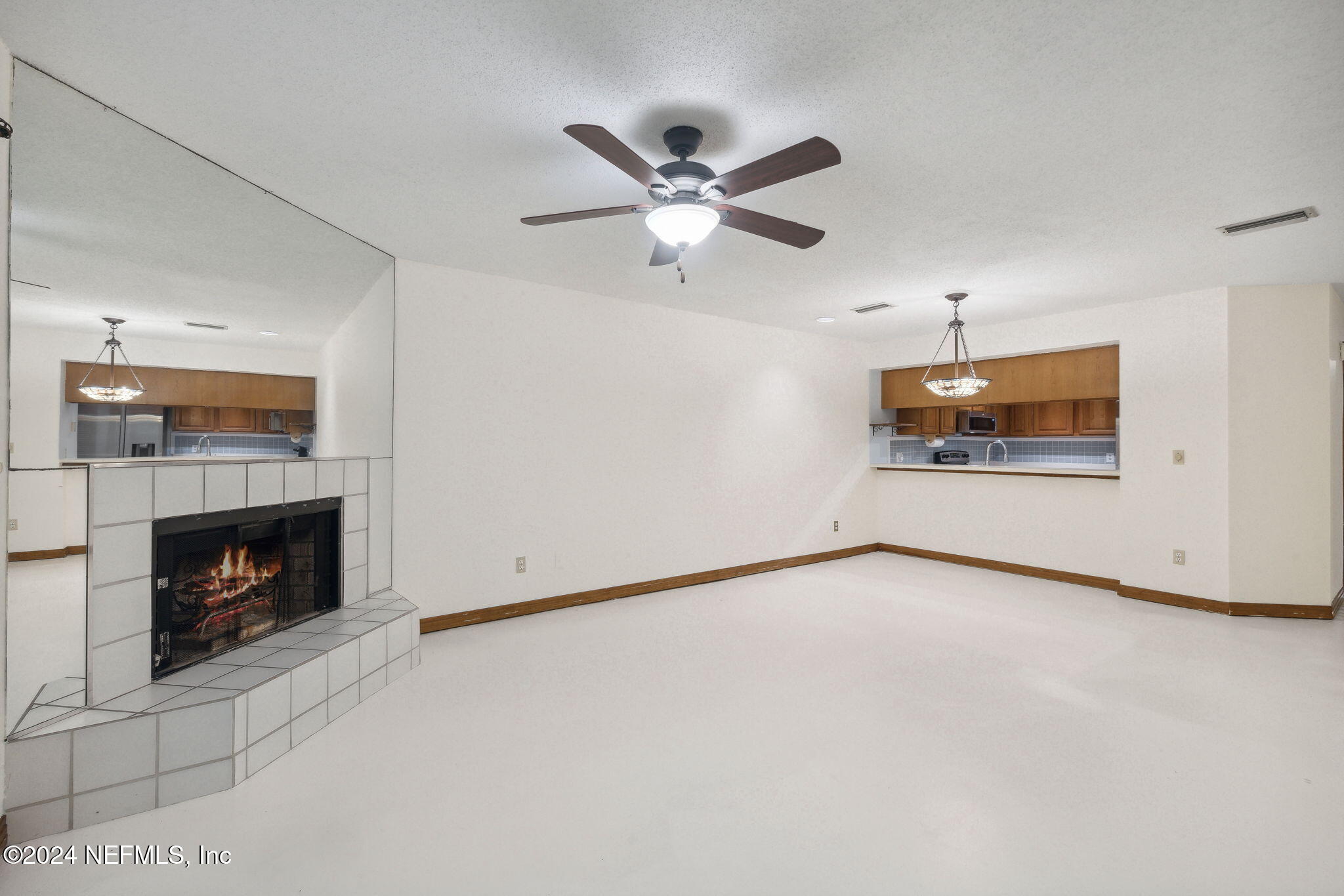10800 Old St Augustine Road, Unit 204 Jacksonville, FL 32257 - Photo 14 of 30 a view of an empty room with fire place and a fireplace