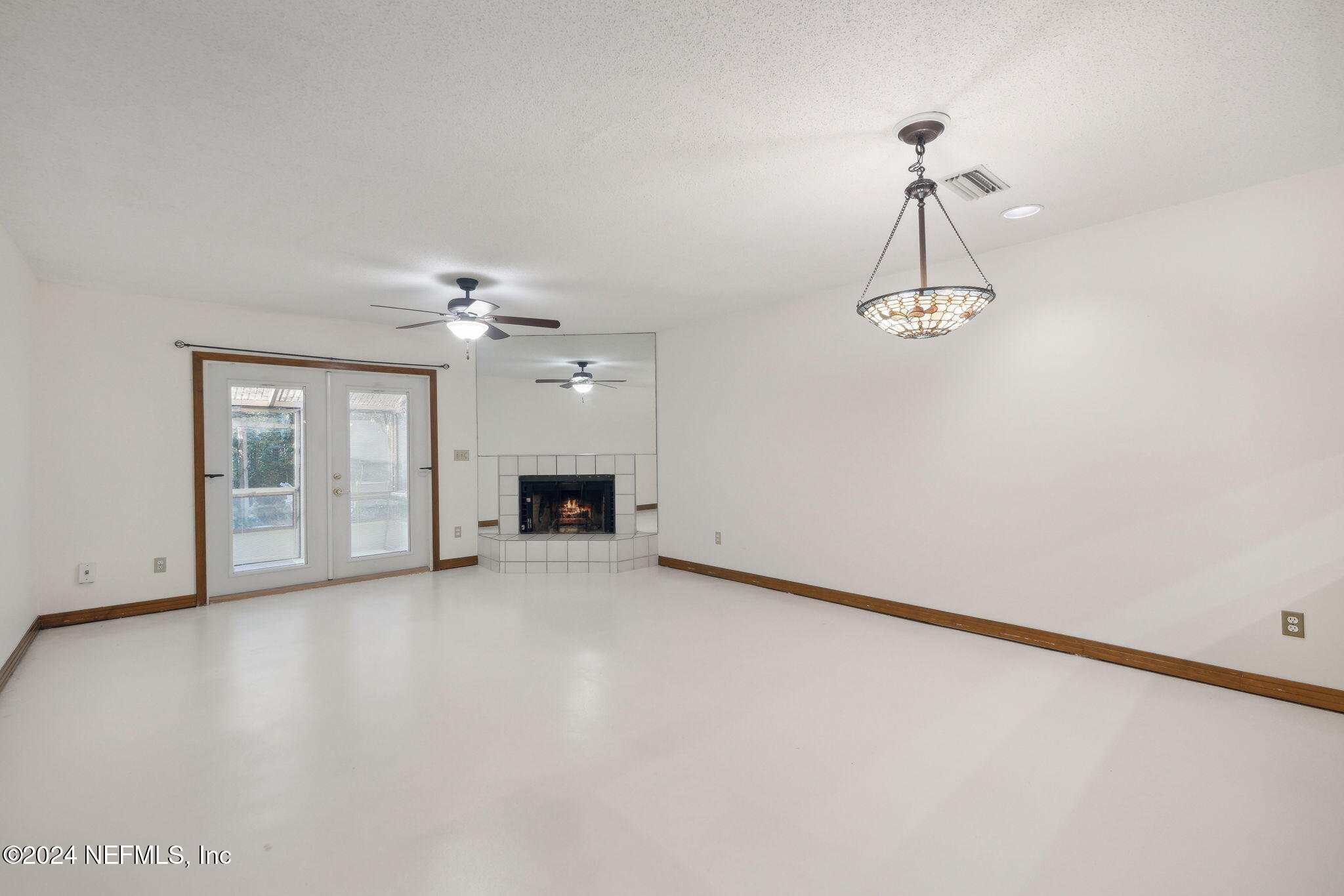 10800 Old St Augustine Road, Unit 204 Jacksonville, FL 32257 - Photo 15 of 30 en empty room with windows and fireplace