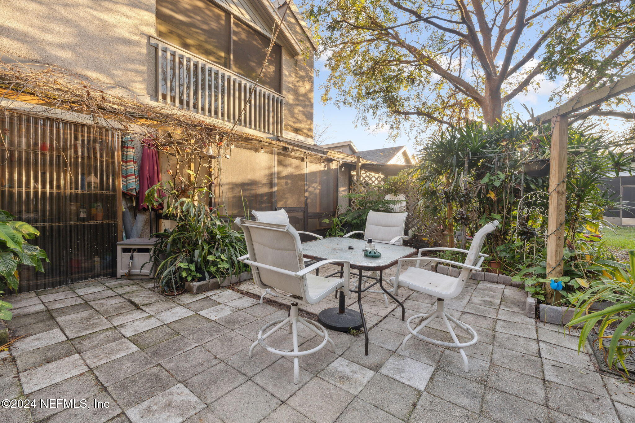 10800 Old St Augustine Road, Unit 204 Jacksonville, FL 32257 - Photo 16 of 30 a view of a patio with table and chairs and potted plants