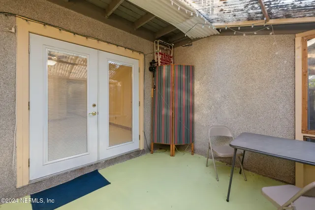 a view of a room with a table and chairs