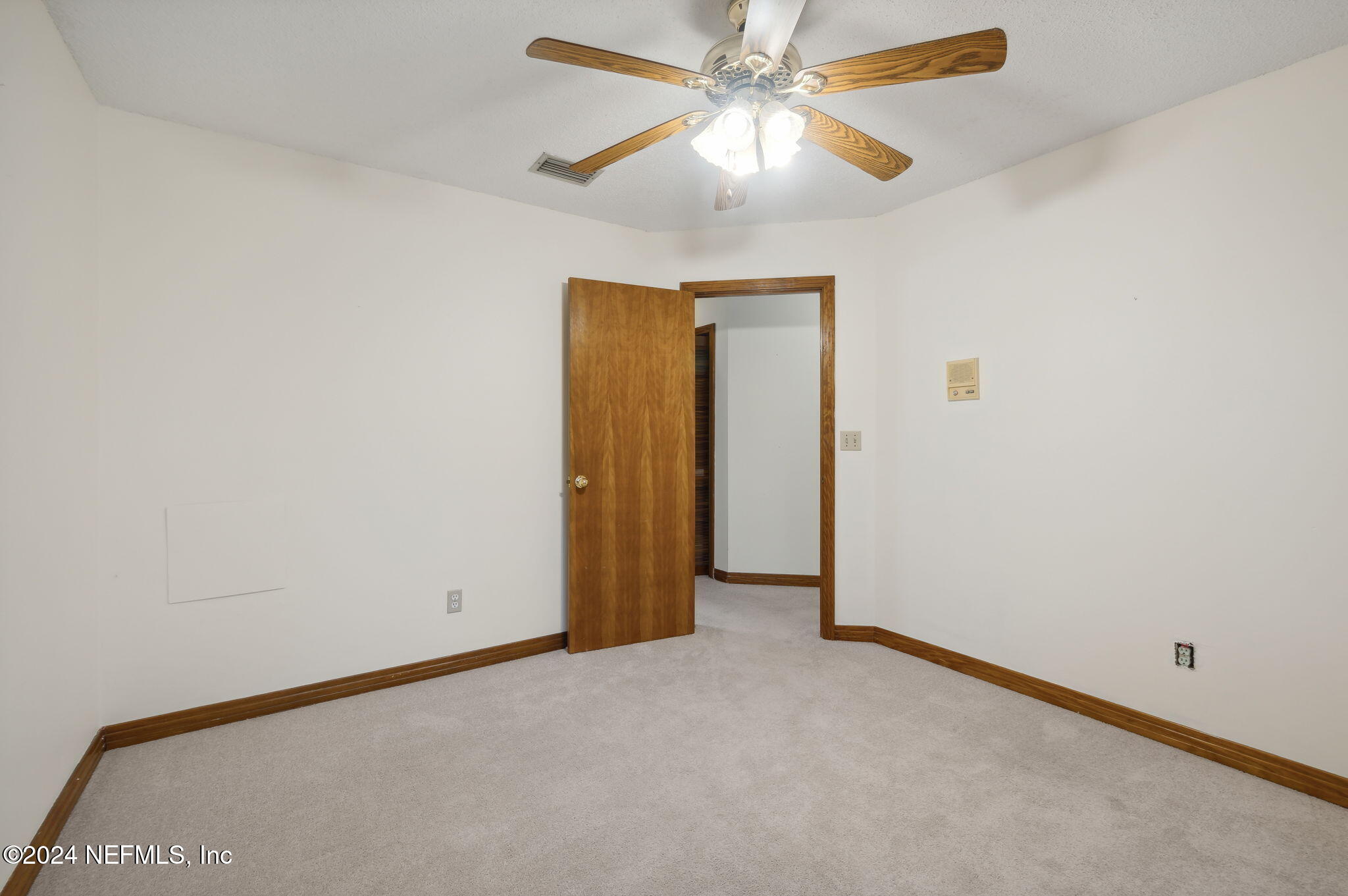 10800 Old St Augustine Road, Unit 204 Jacksonville, FL 32257 - Photo 27 of 30 an empty room with a chandelier fan and closet