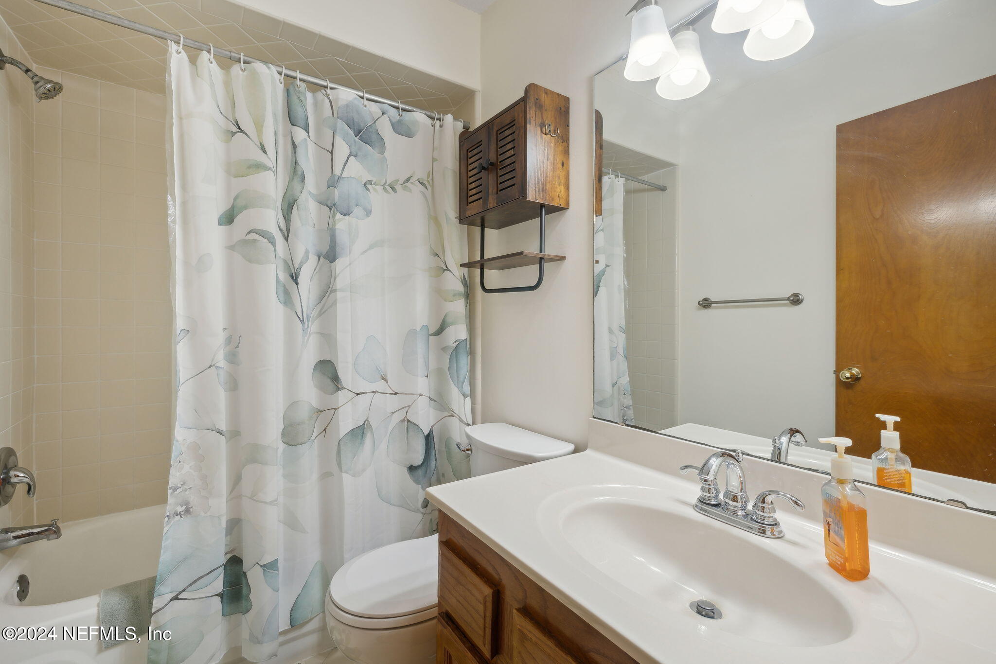 10800 Old St Augustine Road, Unit 204 Jacksonville, FL 32257 - Photo 28 of 30 a bathroom with a sink toilet a mirror and shower