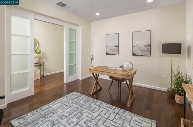 a workspace room with furniture and wooden floor