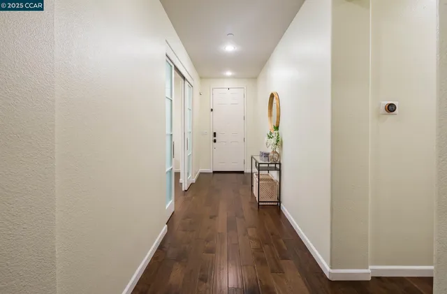 a view of hallway with wooden floor