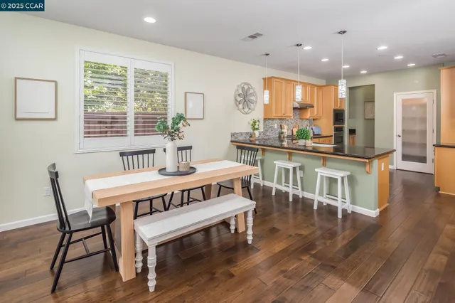 a view of a dining room with furniture window and wooden floor