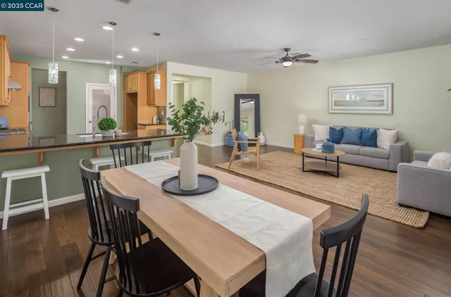 a view of a dining room with furniture and wooden floor