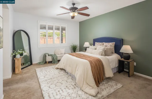 a bedroom with a bed and a potted plant