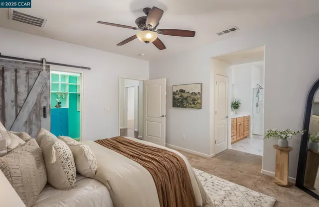a bedroom with a large bed and a chandelier