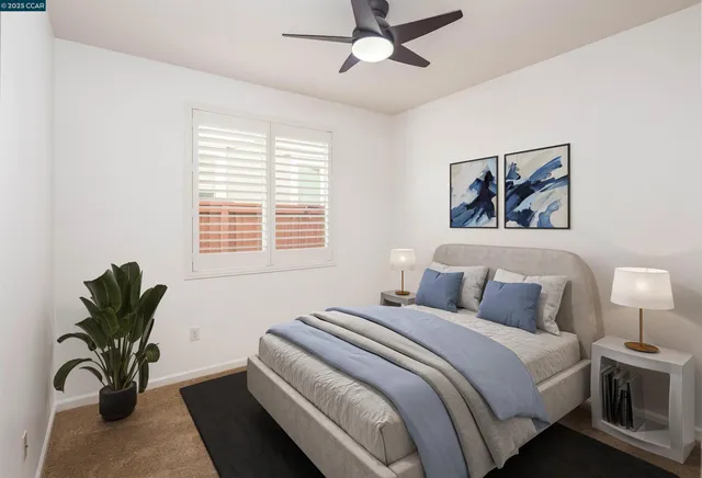 a bedroom with a large bed and a potted plant
