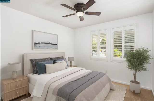 a bedroom with a bed and a potted plant