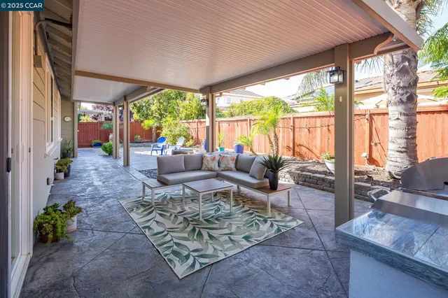 a living room with furniture and floor to ceiling windows