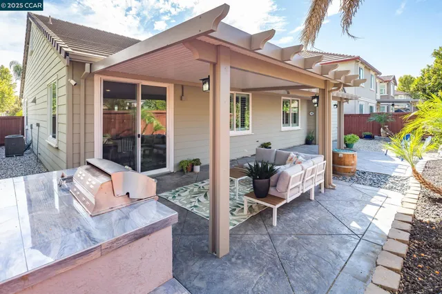 a view of a patio with couches and potted plants