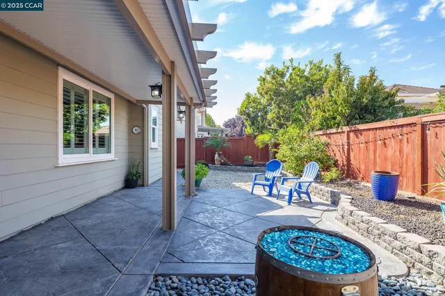 a view of a patio with table and chairs potted plants with wooden fence