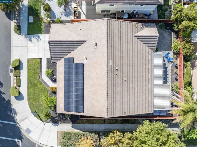a front view of a house with a yard and potted plants