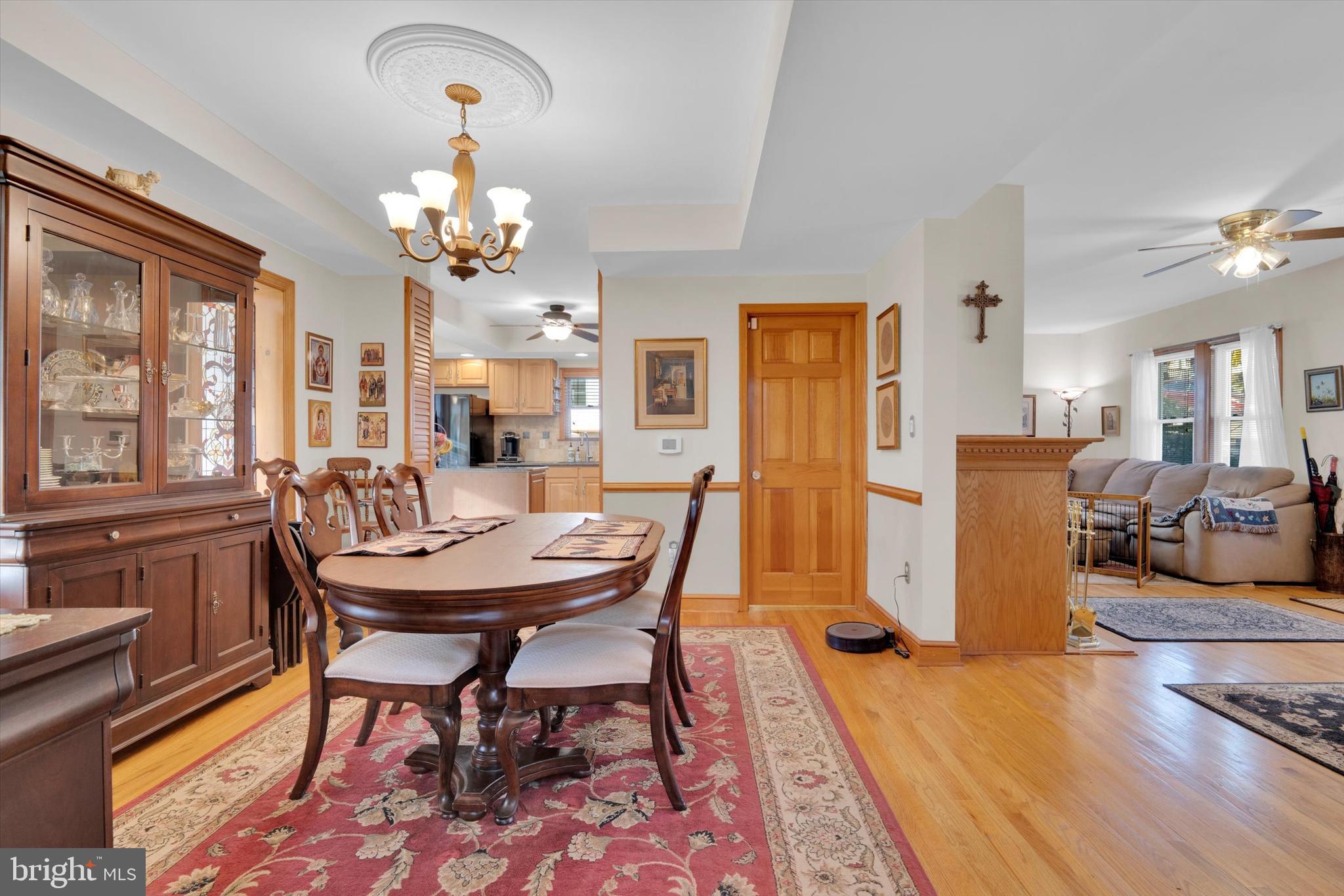 102 Catalpa Road Linthicum Heights, MD 21090 - Photo 14 of 49 a view of a dining room with furniture a chandelier and wooden floor