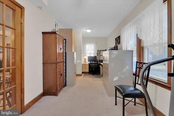 a kitchen with refrigerator a microwave and furniture