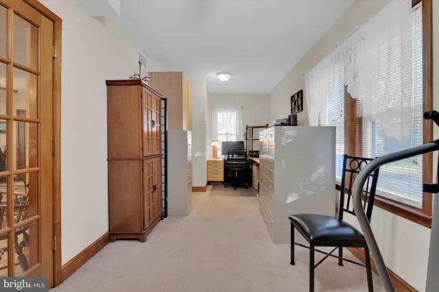 a kitchen with refrigerator a microwave and furniture