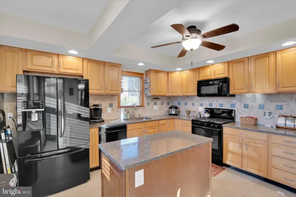 a kitchen with a refrigerator a sink and cabinets