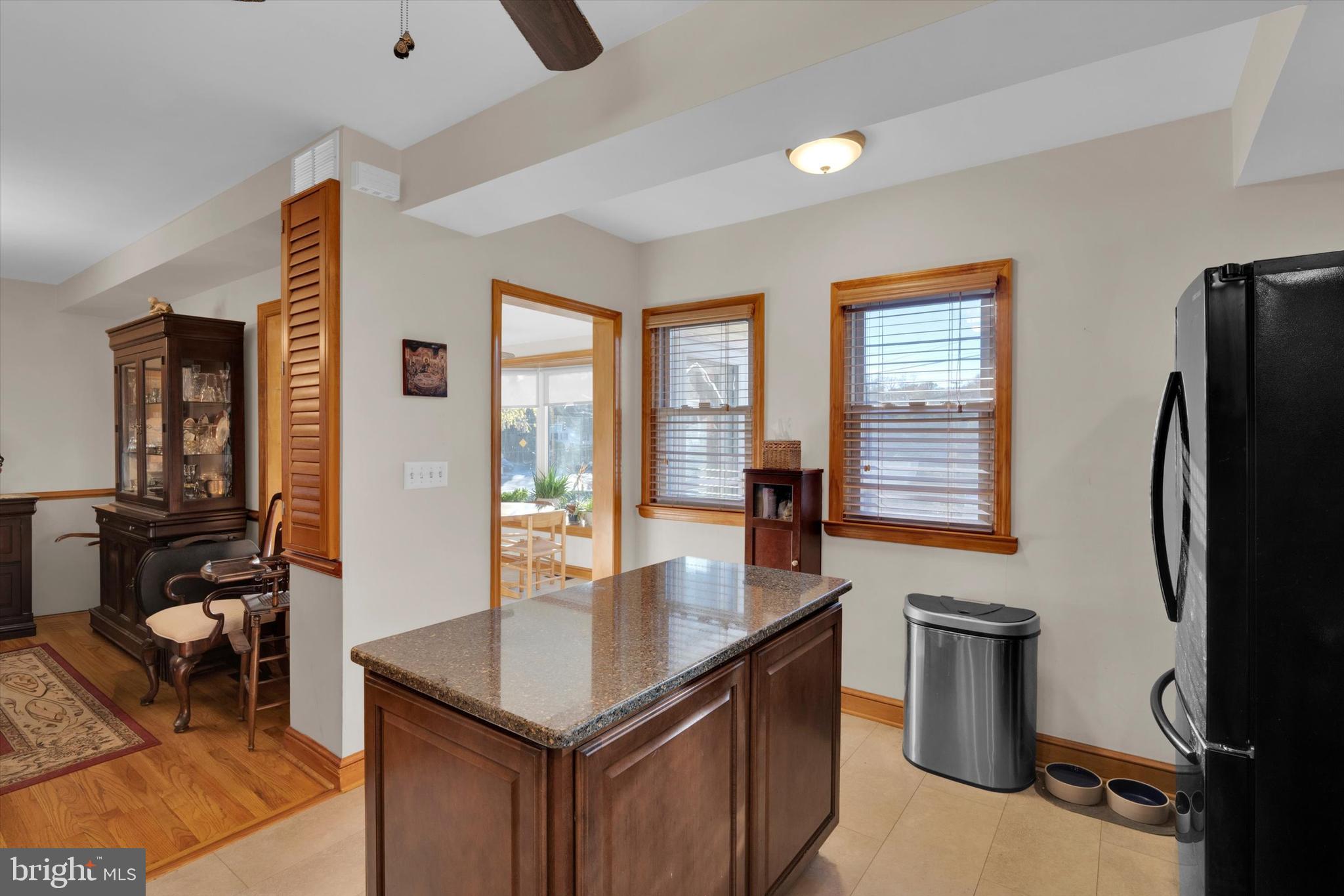 102 Catalpa Road Linthicum Heights, MD 21090 - Photo 22 of 49 a kitchen with stainless steel appliances granite countertop a refrigerator a stove and a sink with living room
