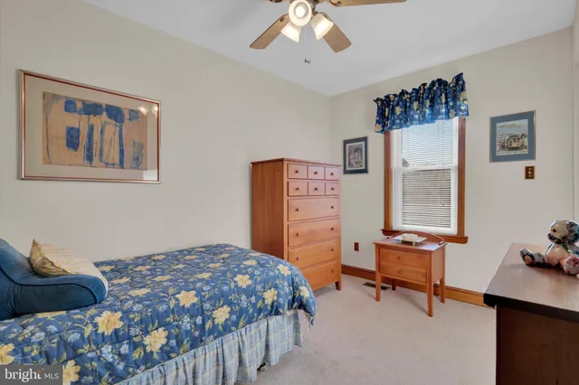 a bedroom that has a bed and a chair in it