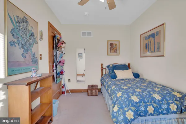 a bedroom with a bed and a couch