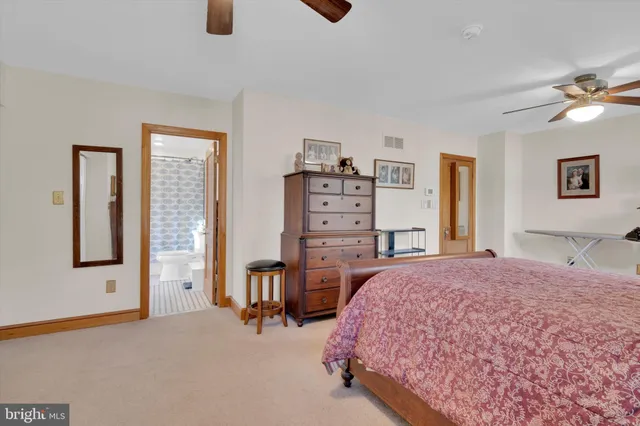 a spacious bedroom with a bed and cabinets