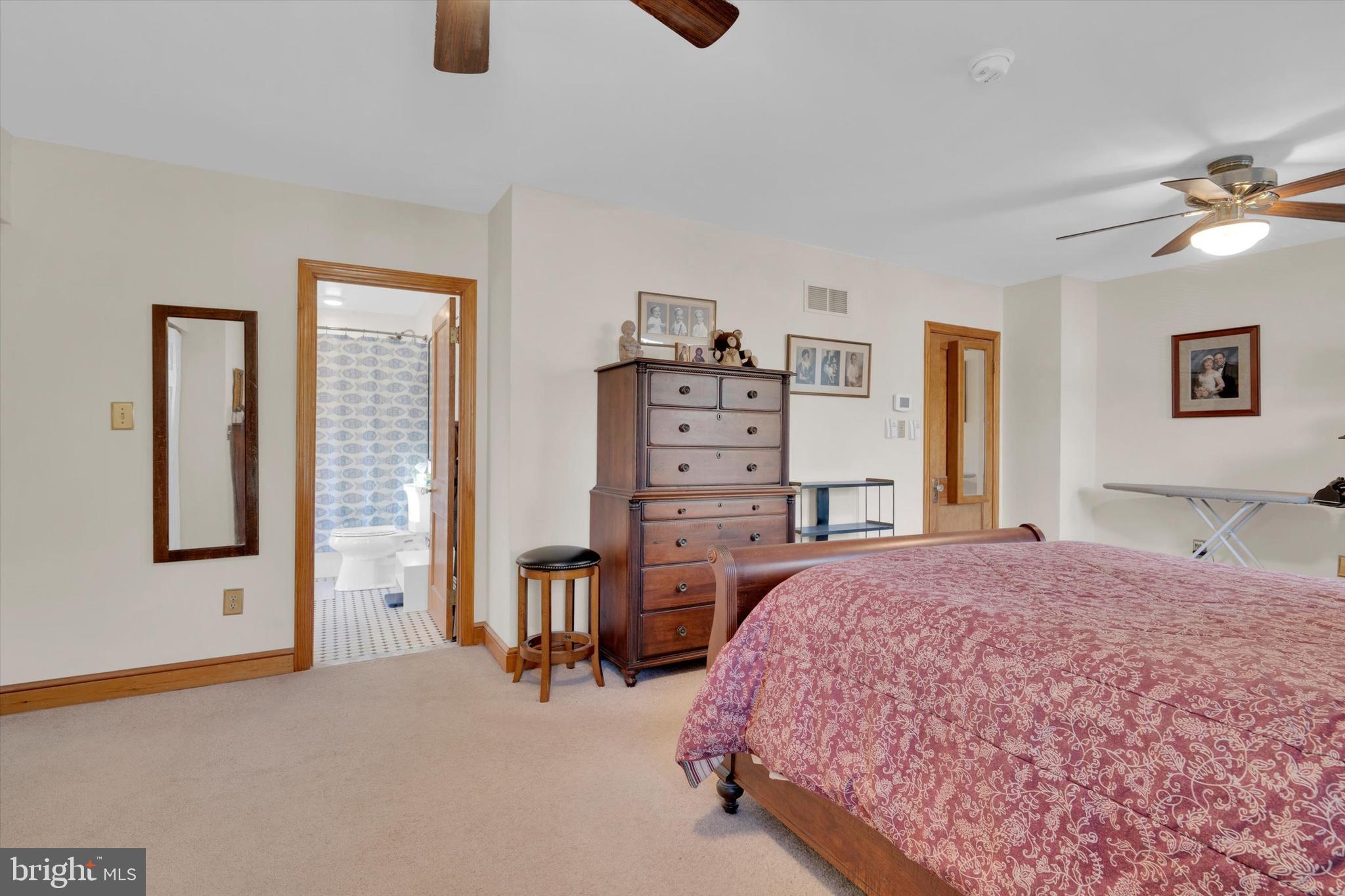 102 Catalpa Road Linthicum Heights, MD 21090 - Photo 35 of 49 a spacious bedroom with a bed and cabinets