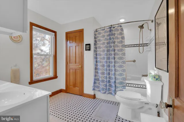 a bathroom with a shower toilet and sink