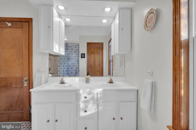 a bathroom with a sink vanity and a mirror