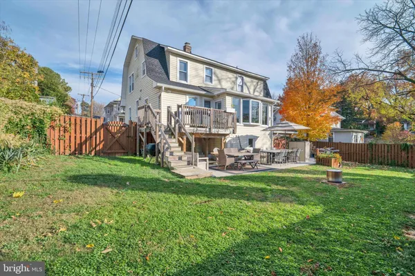 a view of a house with a yard and sitting area