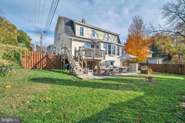 a view of a house with a yard and sitting area