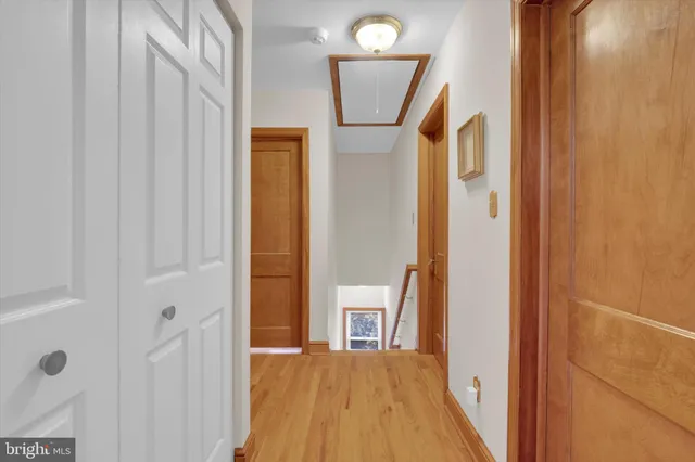 a view of a hallway with wooden floor and entryway
